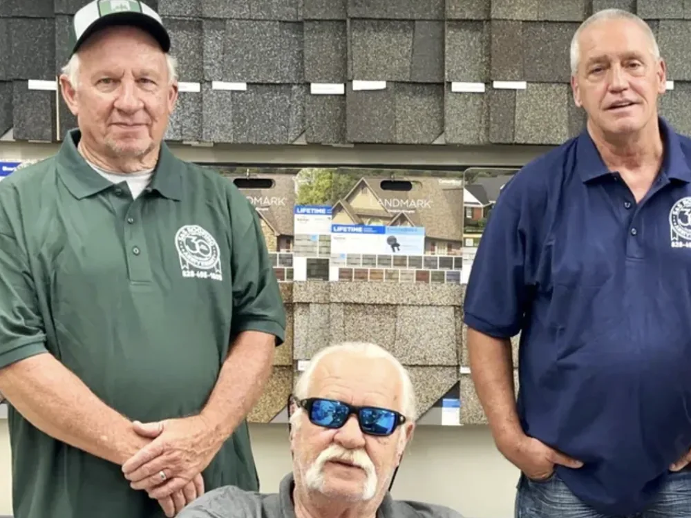 James Fisk, owner of S&S Roofing (seated, center), with the S&S Roofing team at the Taylorsville, NC showroom