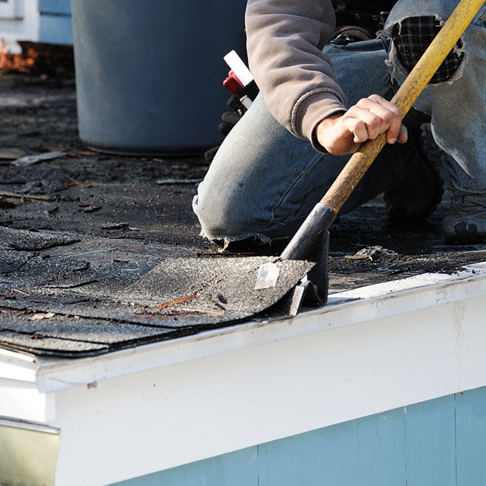 contractor-close-up-with-shovel-removing-damaged-asphalt-shingles-roof-taylorsville-nc