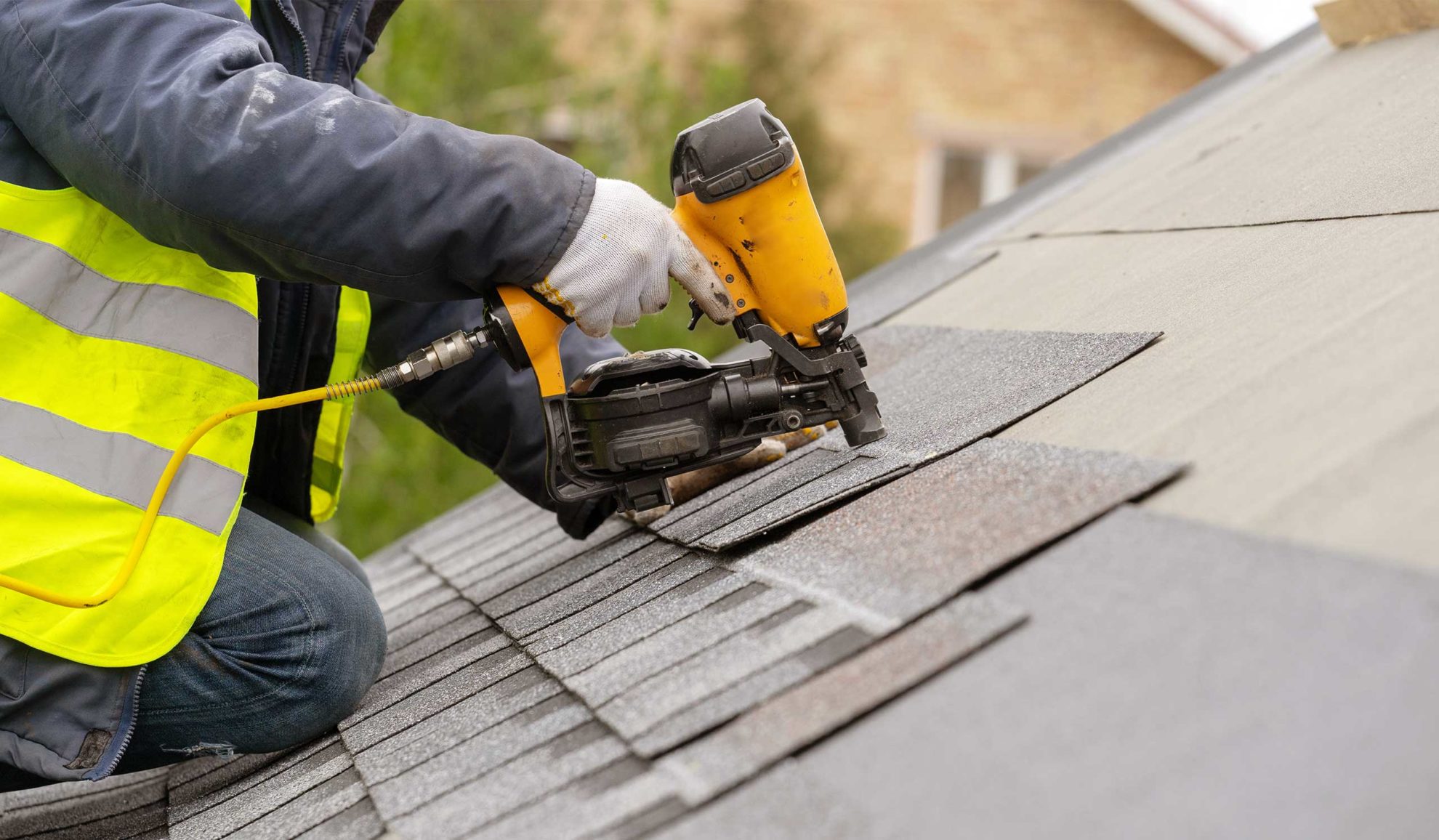 contractor-hands-with-protection-gloves-and-nailgun-installing-asphalt-shingles-taylorsville-nc